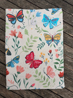 Housse de livre matelassée papillons colorés fond écru: M